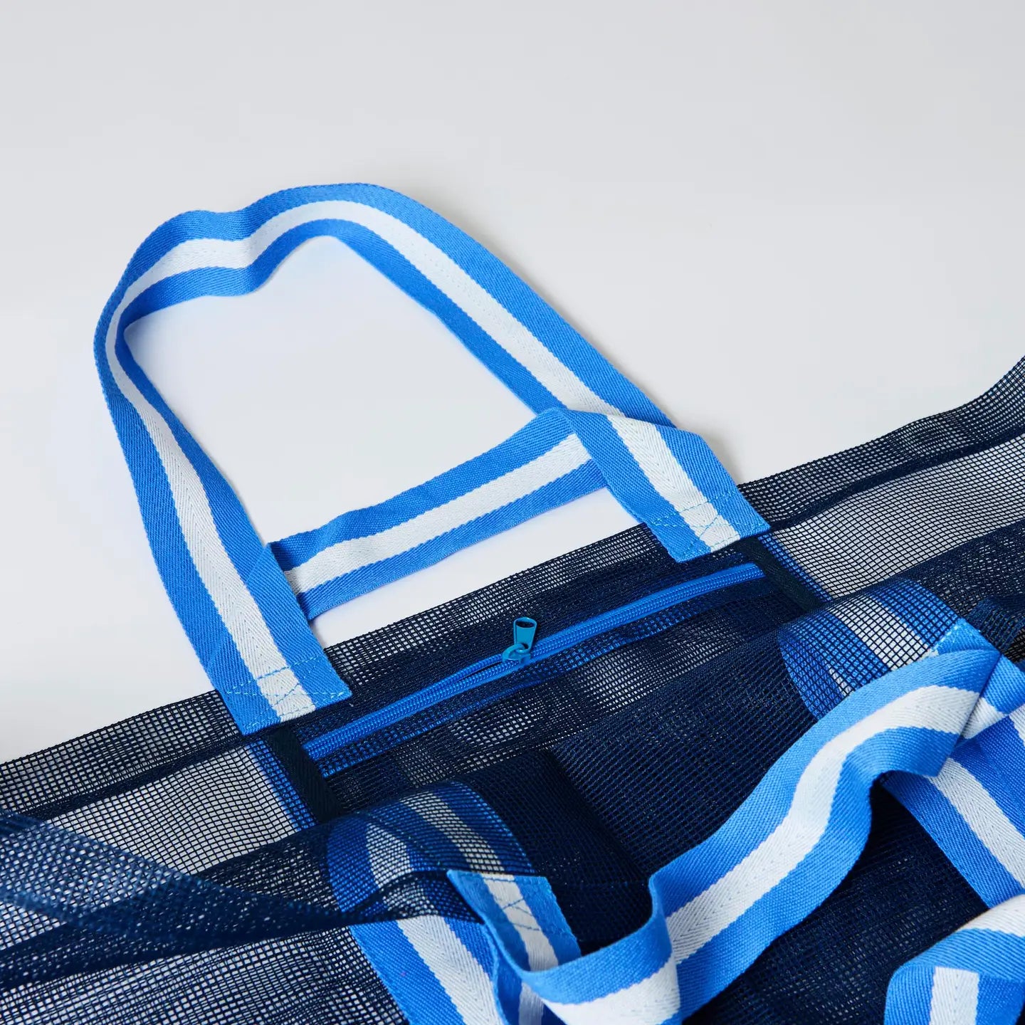 Close-up of blue striped woven tote bag handles
