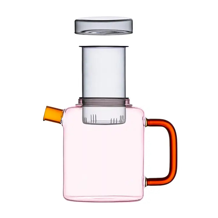 Pink glass Cha Pot with a clear infuser, yellow spout, and orange handle on a white background