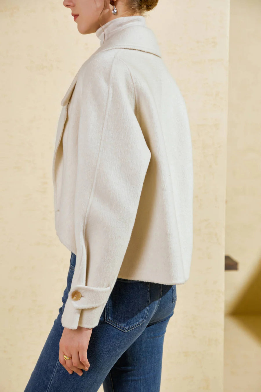 Side view of Luciano short coat showing tailored lapel and structured silhouette