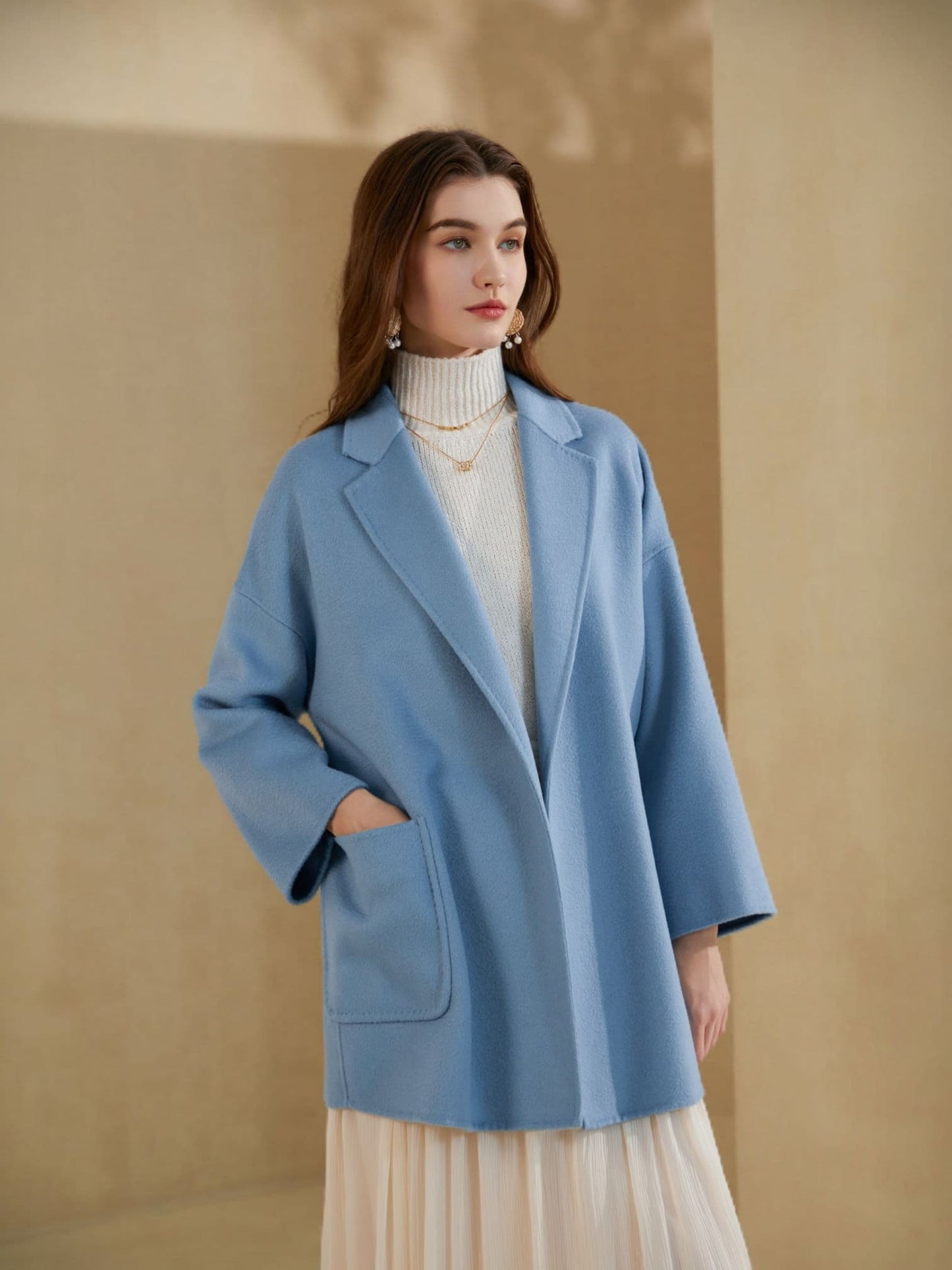 “Model wearing sky blue merino wool wrap coat – Nova Lux women’s winter outerwear”