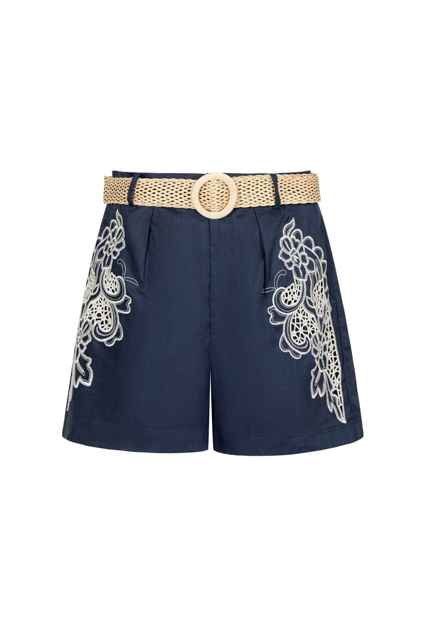“Navy embroidered shorts with white floral lace details and a beige woven belt on a white background.”