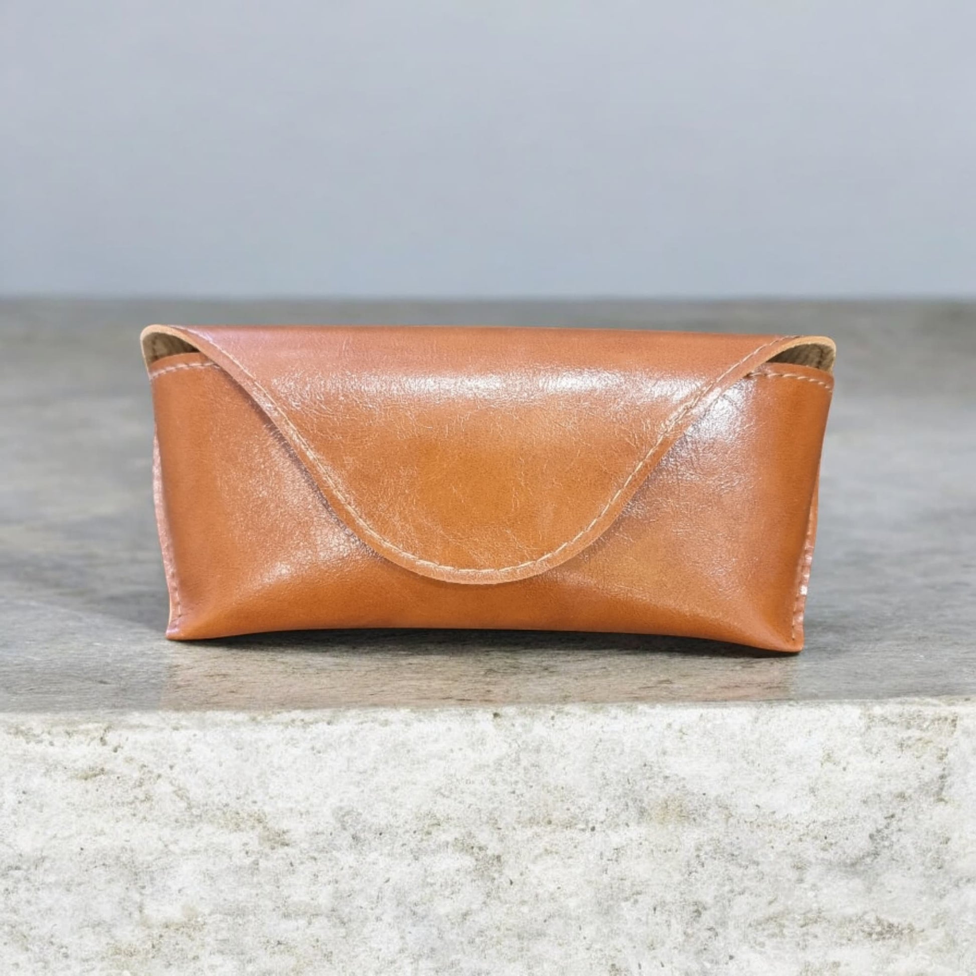 Closed brown sunglasses case on grey background – Nova Lux