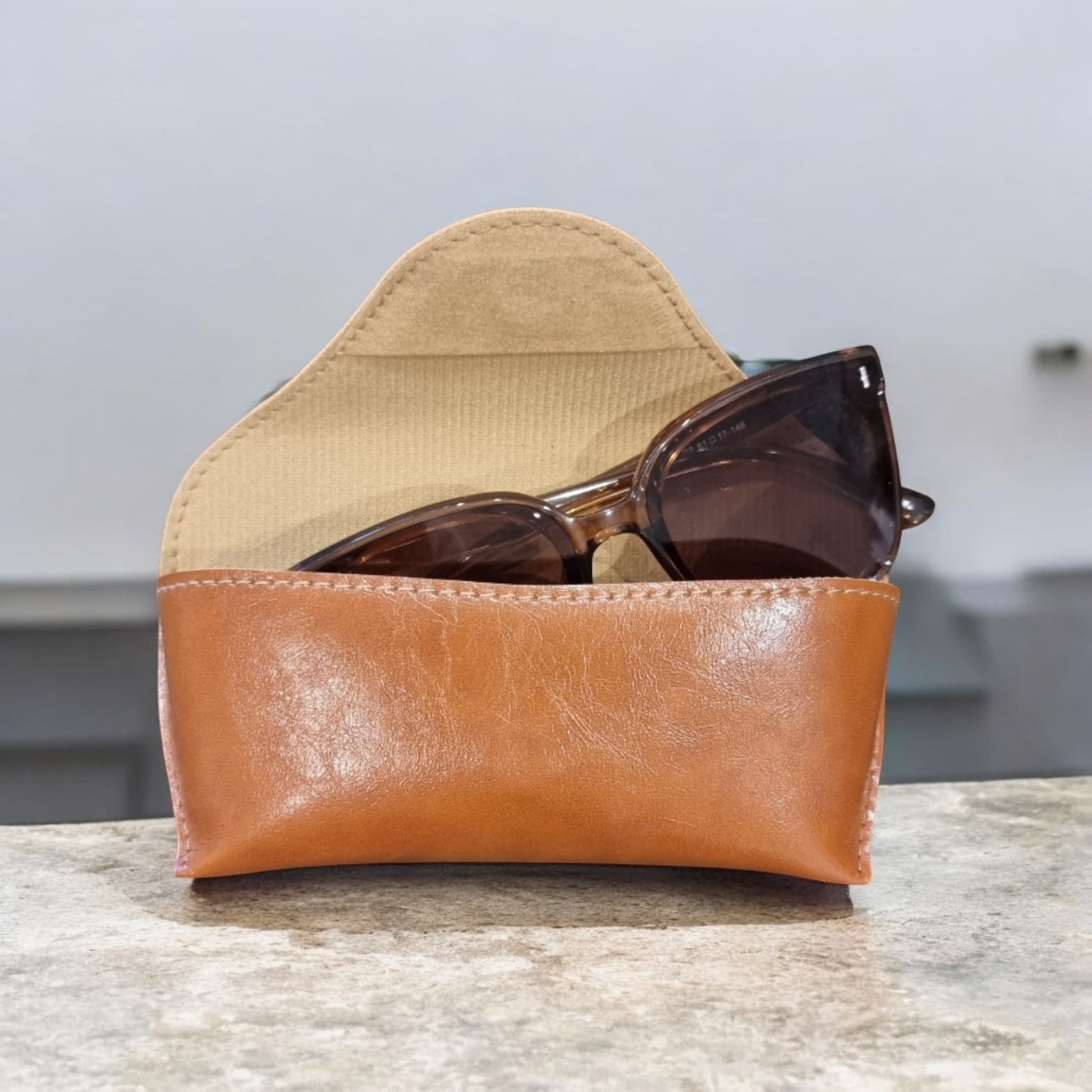 Side view of brown sunglasses case showing curved flap – Nova Lux