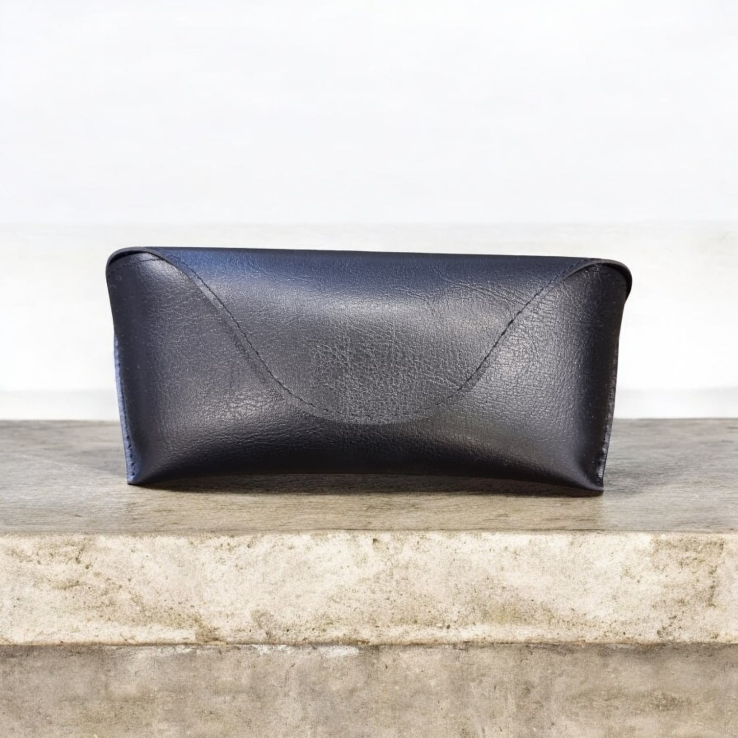 Side view of black sunglasses case showing curved flap – Nova Lux