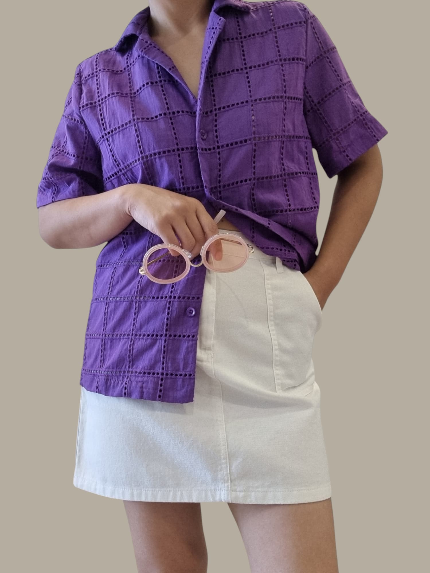 Woman wearing purple HAYLIE SHIRT styled with a white skirt