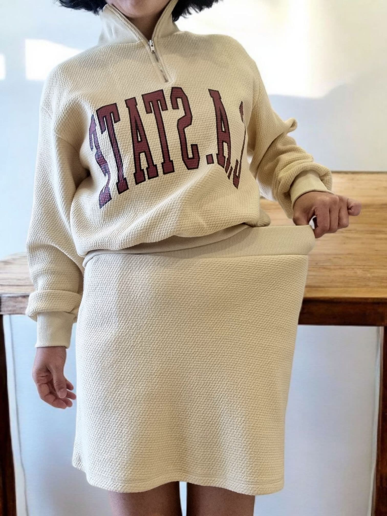 Side view of beige CA Mt Skirt showing straight silhouette and comfortable fit
