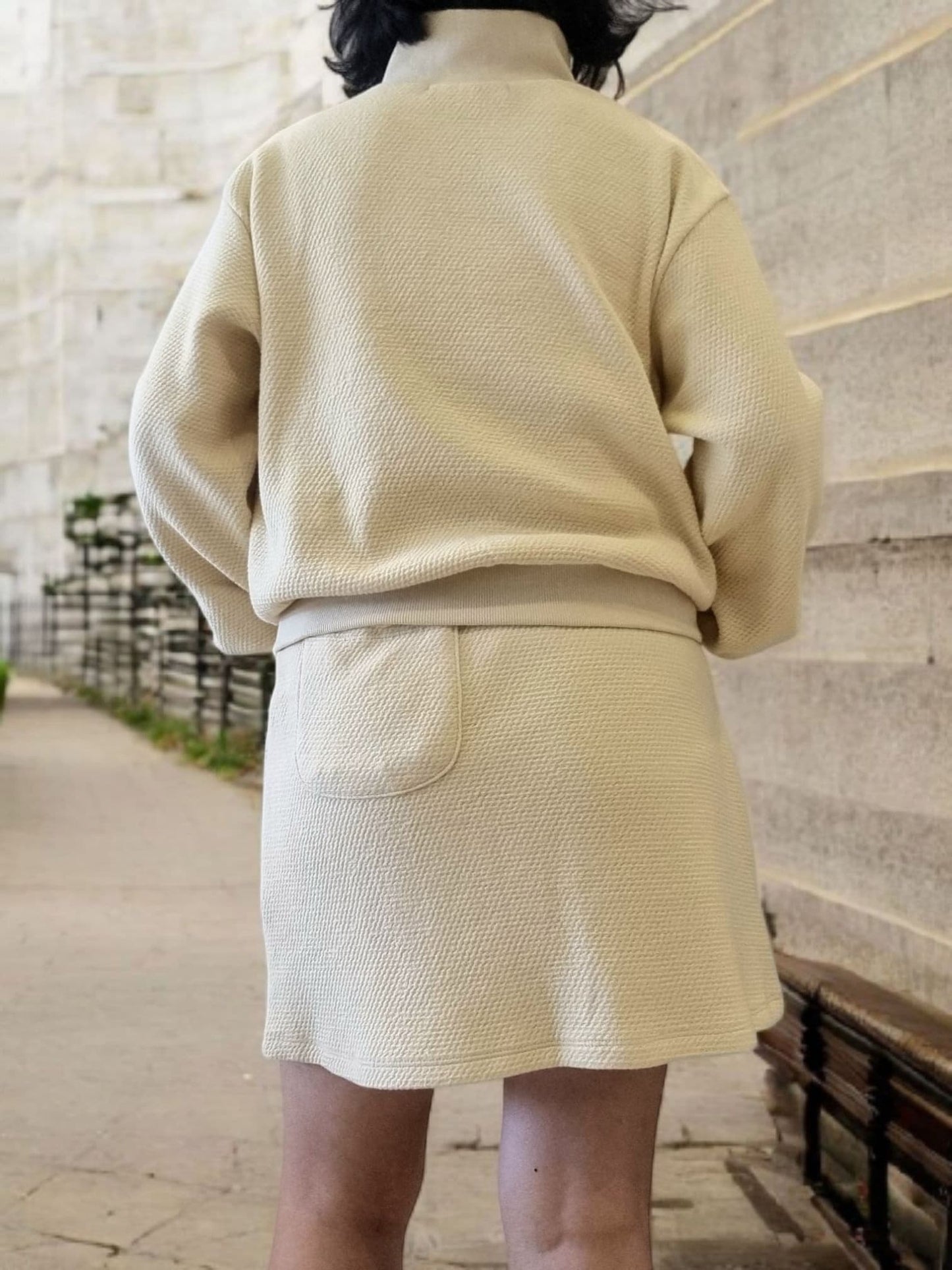 Back view of F CA Mt Skirt showing relaxed length and inner pants coverage
