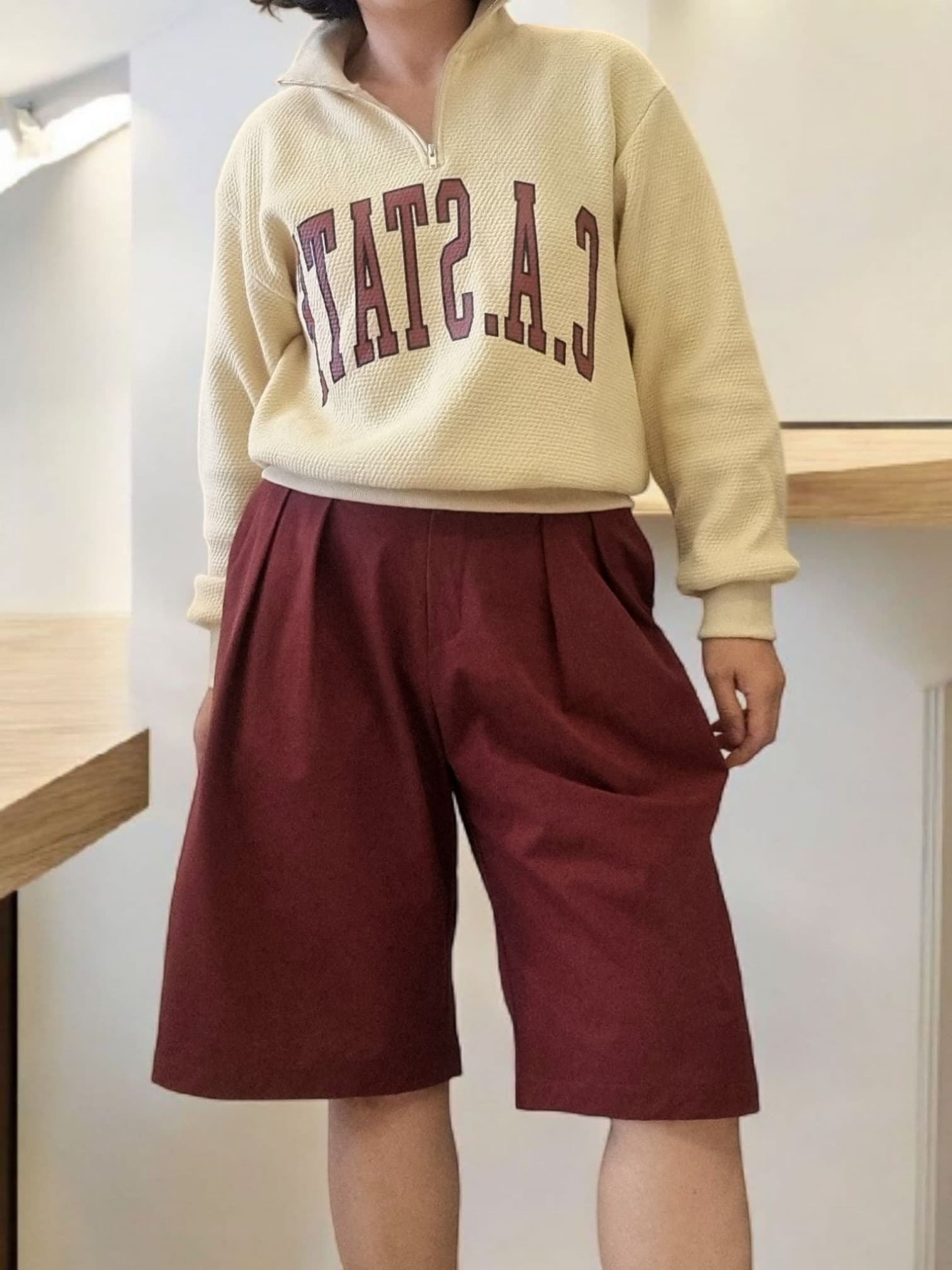 Model wearing burgundy wide-leg pants with sweatshirt – front view