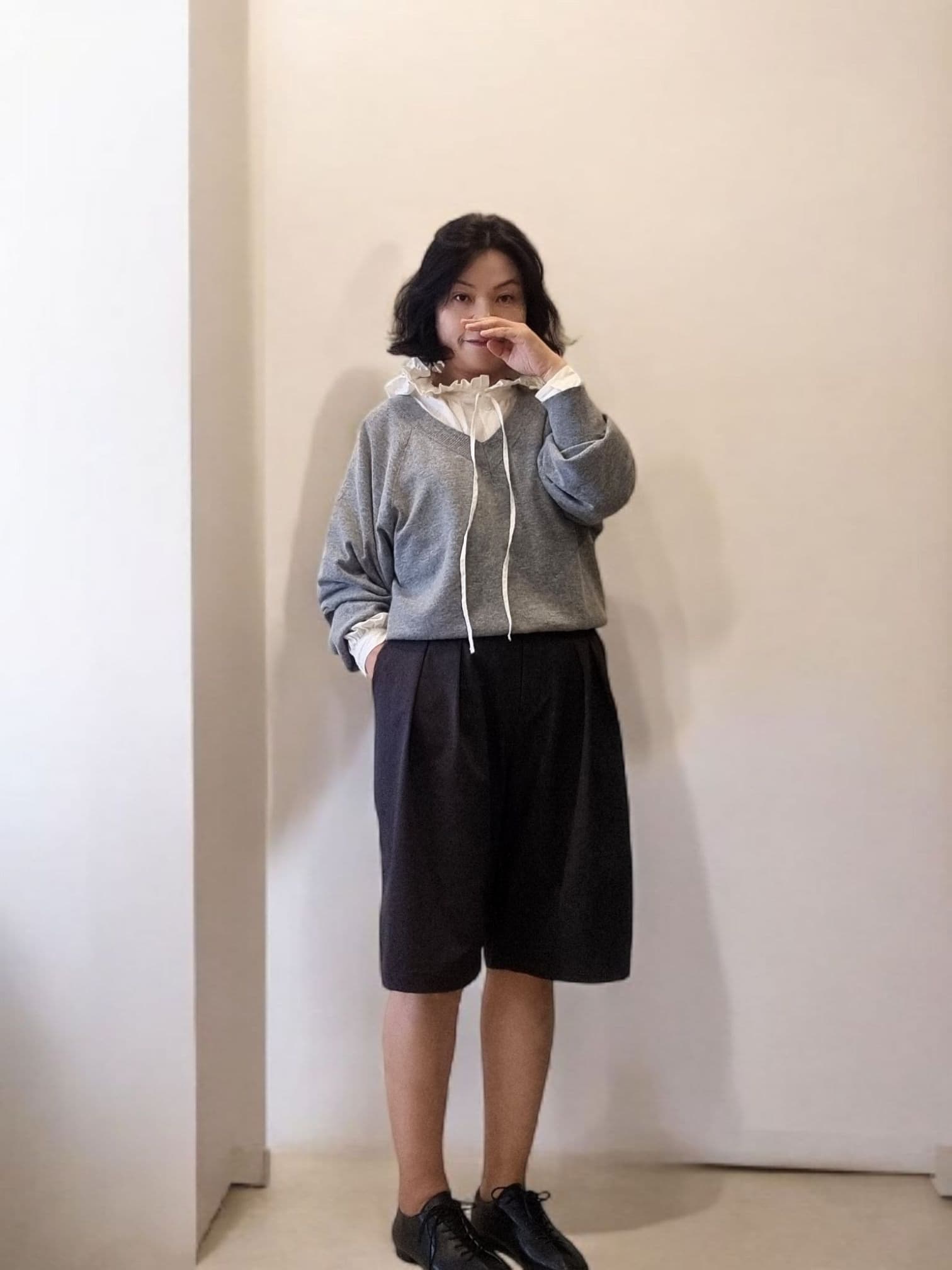 Model wearing charcoal wide-leg pants – full body front view