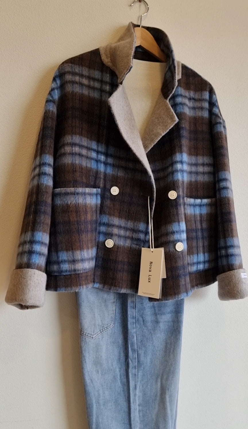Blue plaid wool coat with double-breasted design and relaxed fit