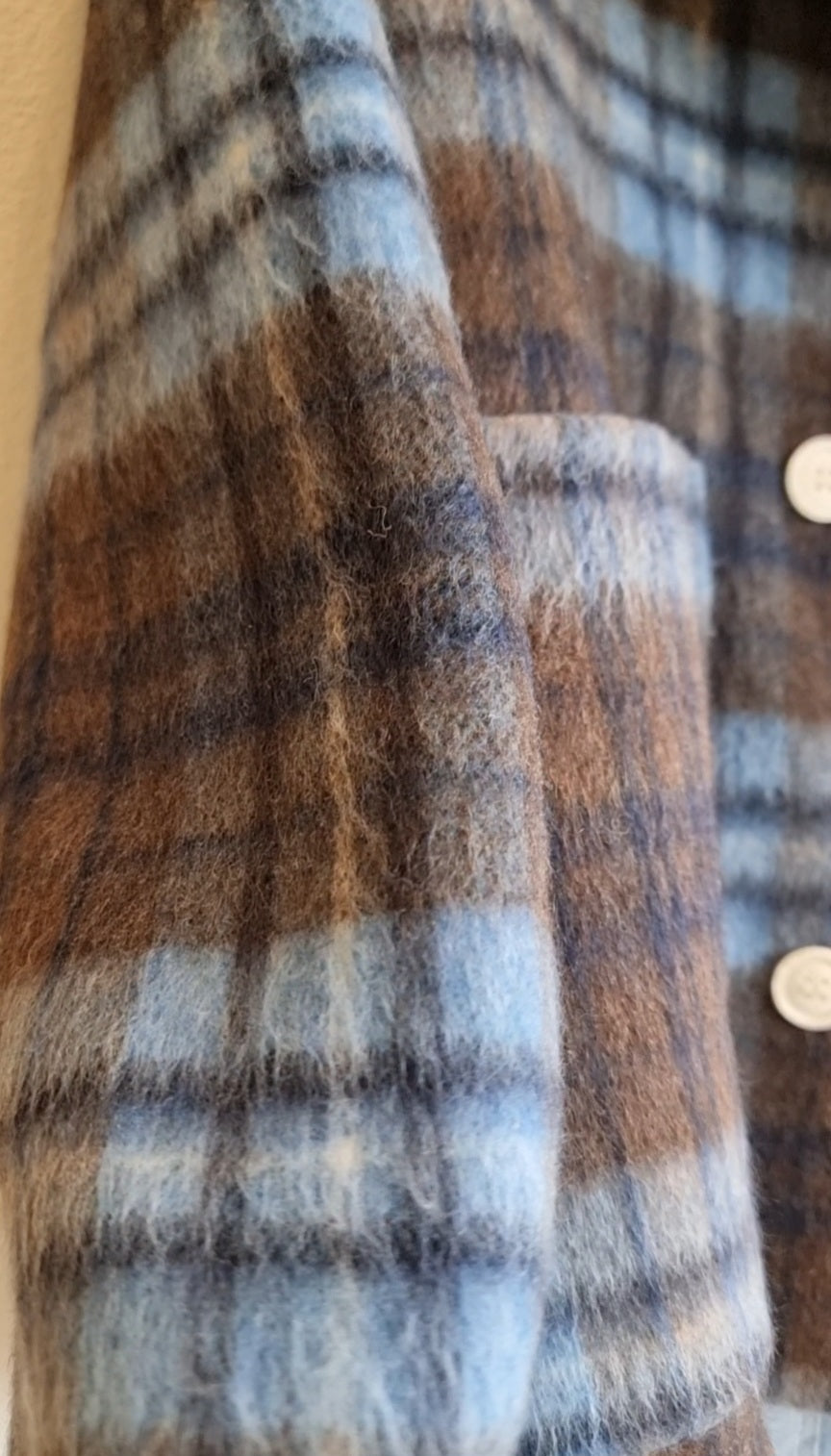 Close-up texture of blue plaid wool coat