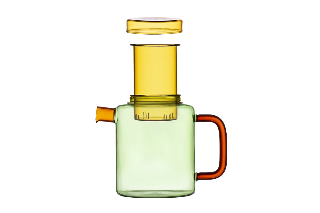 Green glass teapot with a yellow infuser and lid, and an orange handle on a transparent background