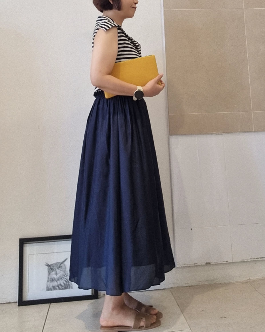 Side view of a navy silk skirt dress with elastic waist and cotton lining, styled with a striped sleeveless top and yellow clutch, worn by a 160cm model in size 10.