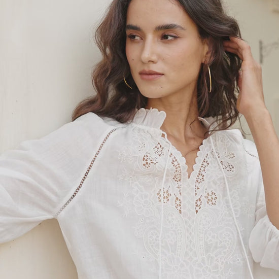 “Flowy white embroidered shorts shown on a model outdoors, highlighting its breezy summer look and comfortable bohemian style.”