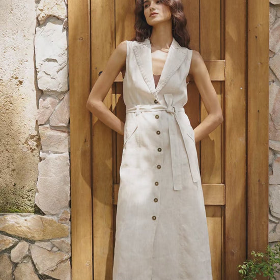 “Model wearing a beige linen dress walking outdoors — showcasing the dress’s relaxed, lightweight fabric, soft silhouette, and natural texture. Summer linen one-piece, breathable material, neutral tone outfit, timeless casual style.”