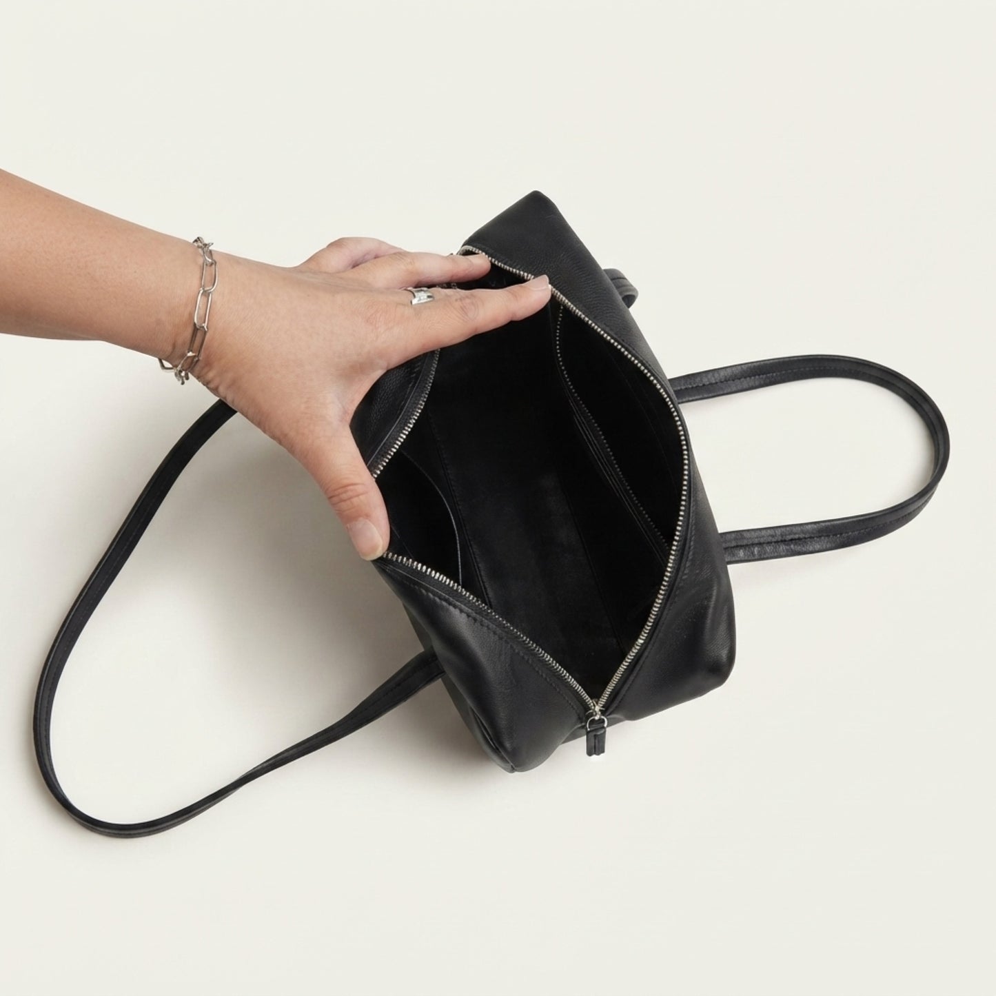 Black genuine leather handbag with spacious interior and shoulder straps