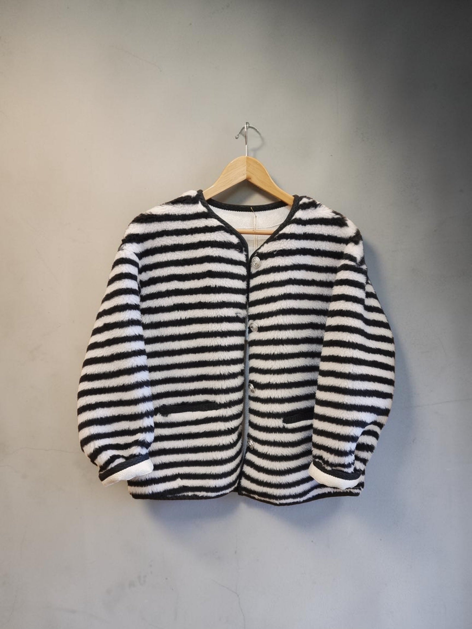 Black and cream striped wool jacket flat lay