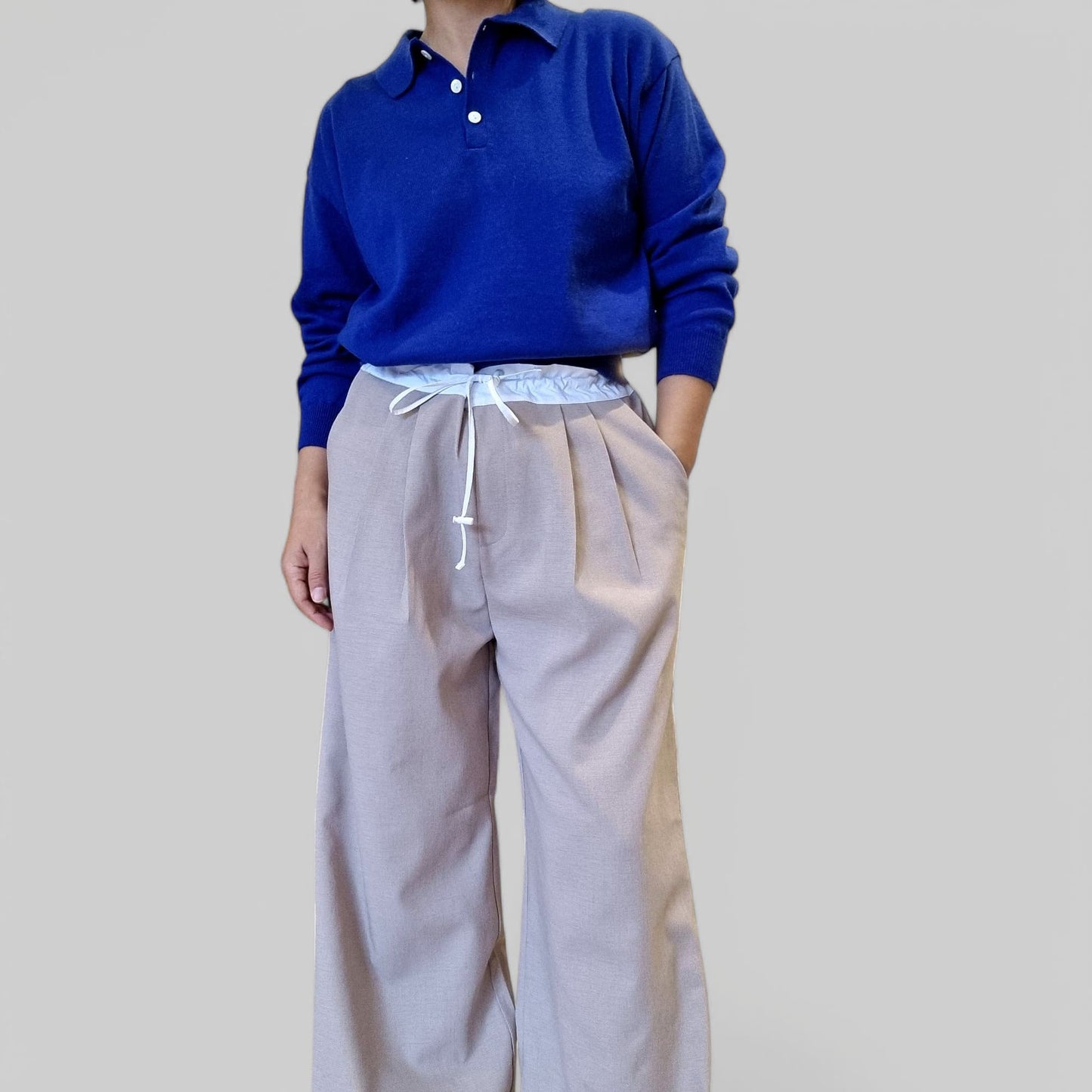 “Model styling blue cotton top in indoor boutique setting”