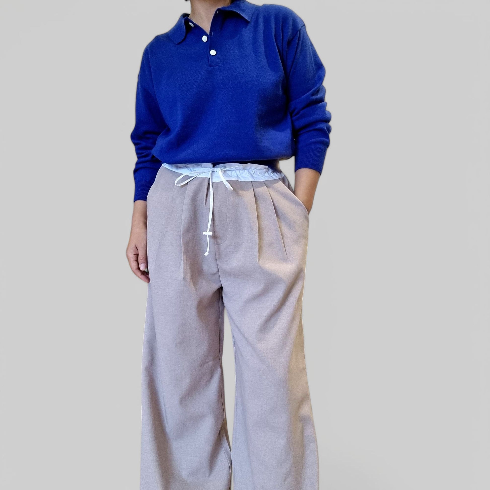 “Model styling blue cotton top in indoor boutique setting”