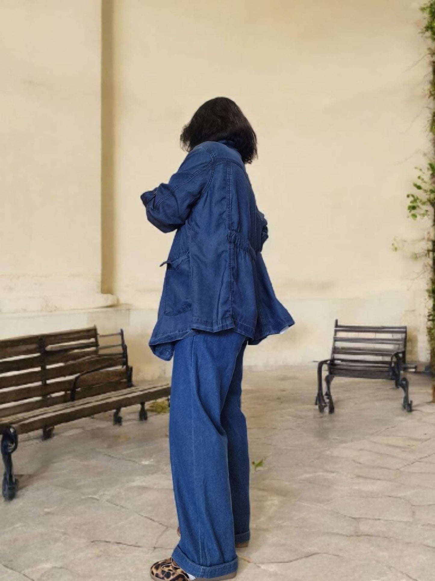 “Back view of relaxed-fit blue cotton jacket with long silhouette.”