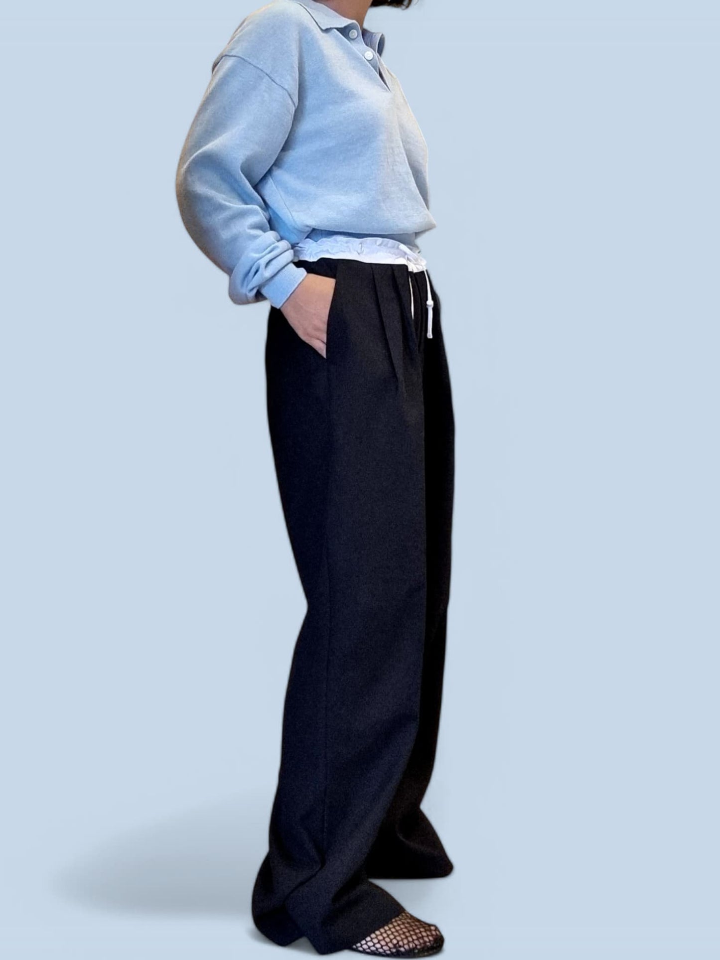 “Side angle of blue cotton top with relaxed fit”