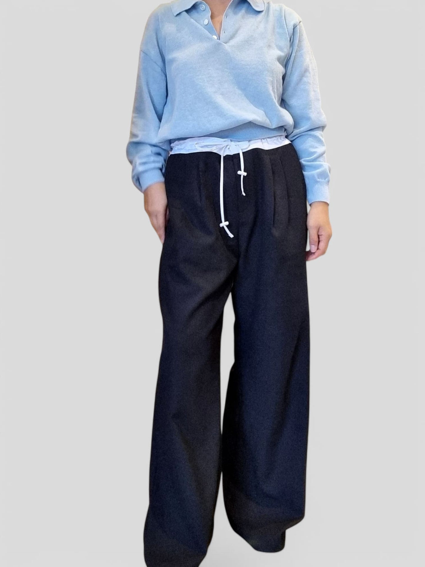 “Light blue cotton top paired with navy wide-leg pants, front view against a plain background”