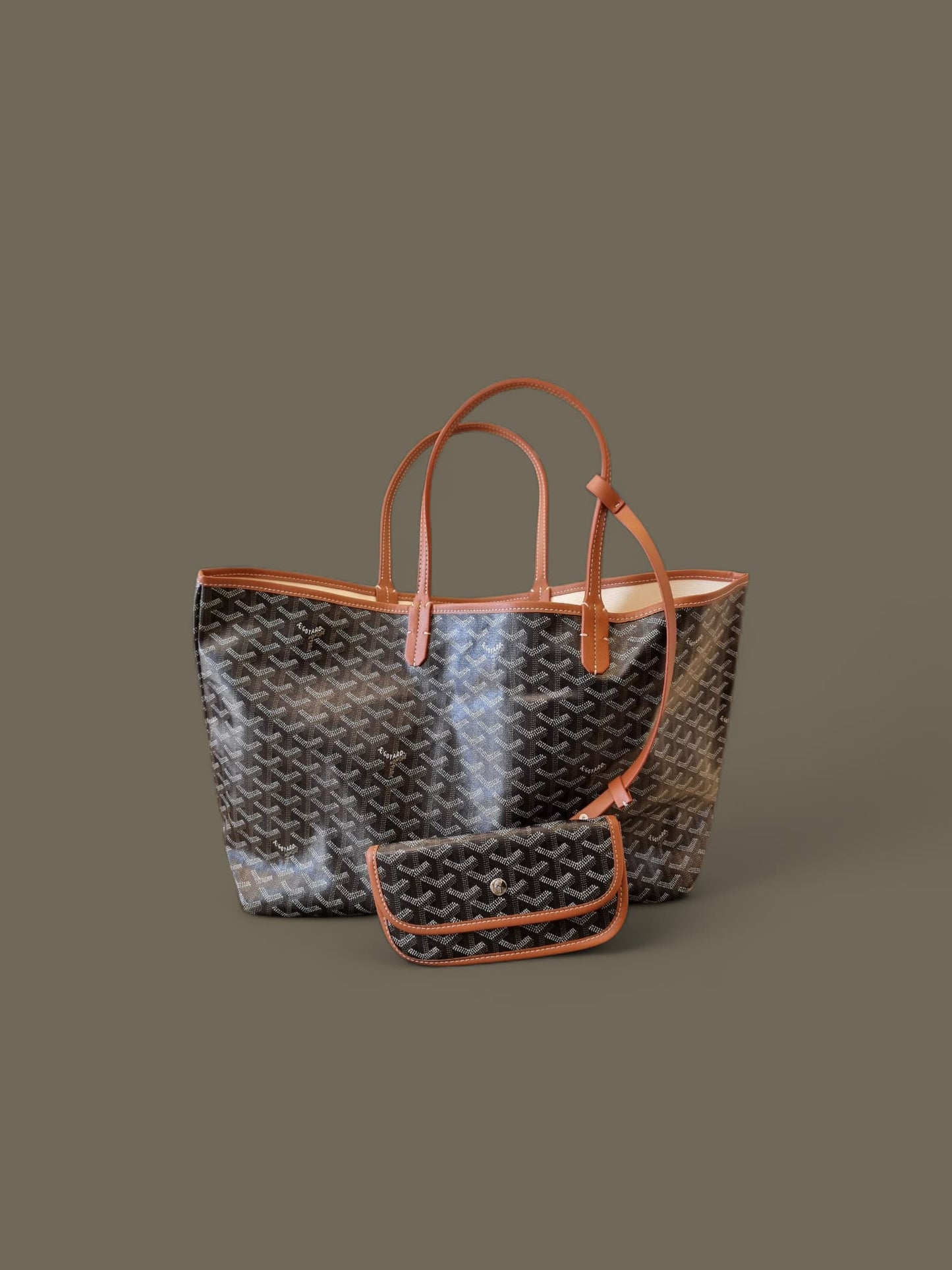 Large patterned tote bag with orange handles on a neutral backdrop