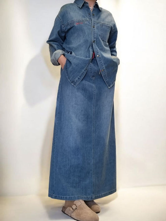 Model wearing long denim skirt full front view.