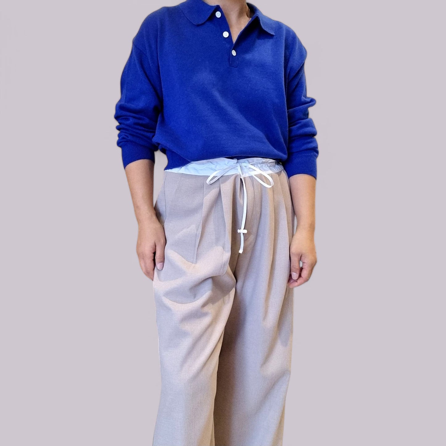 “Model wearing royal blue cotton top with white trousers”