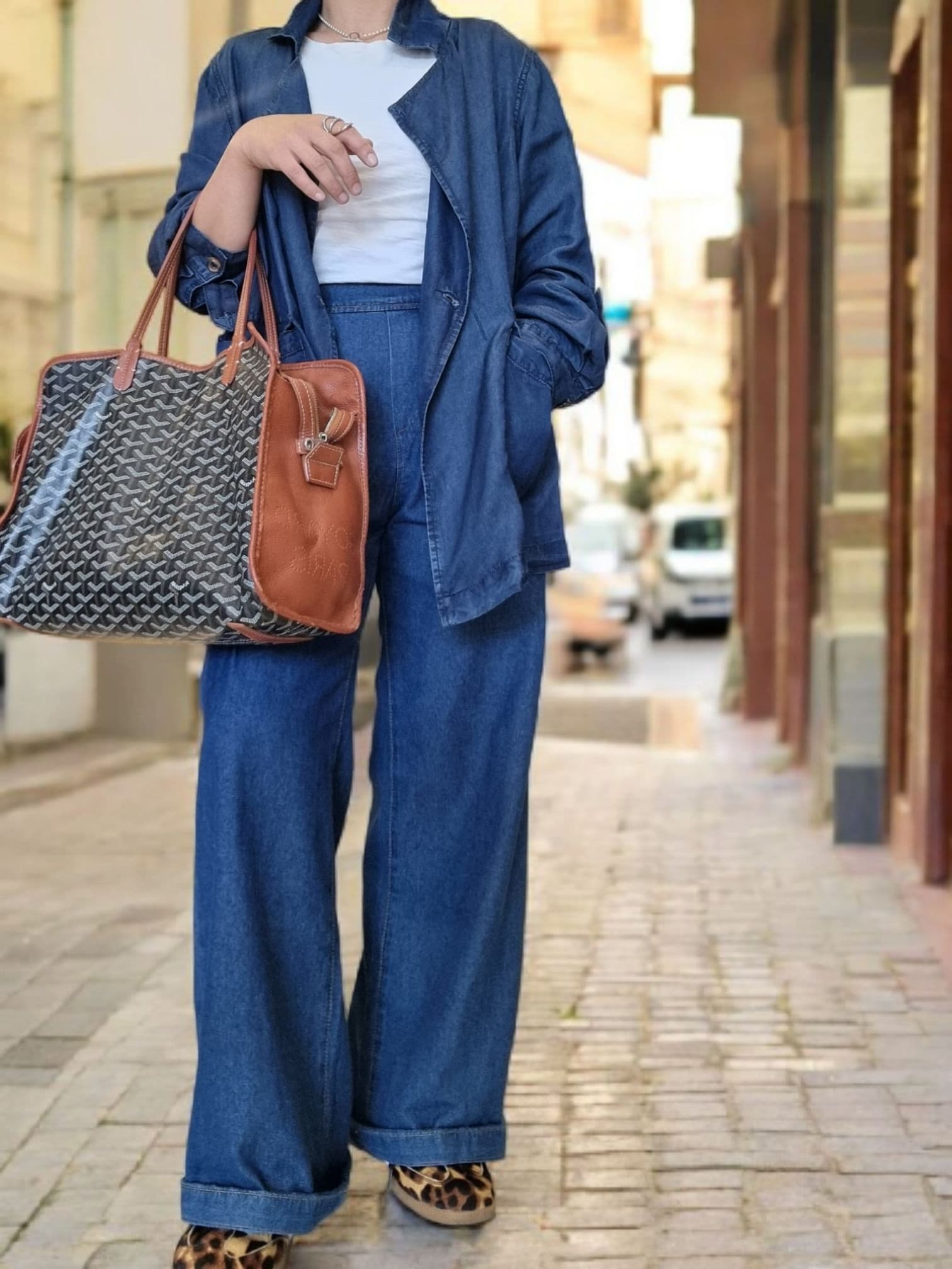 “Street-style view of blue cotton jacket worn over matching trousers.”