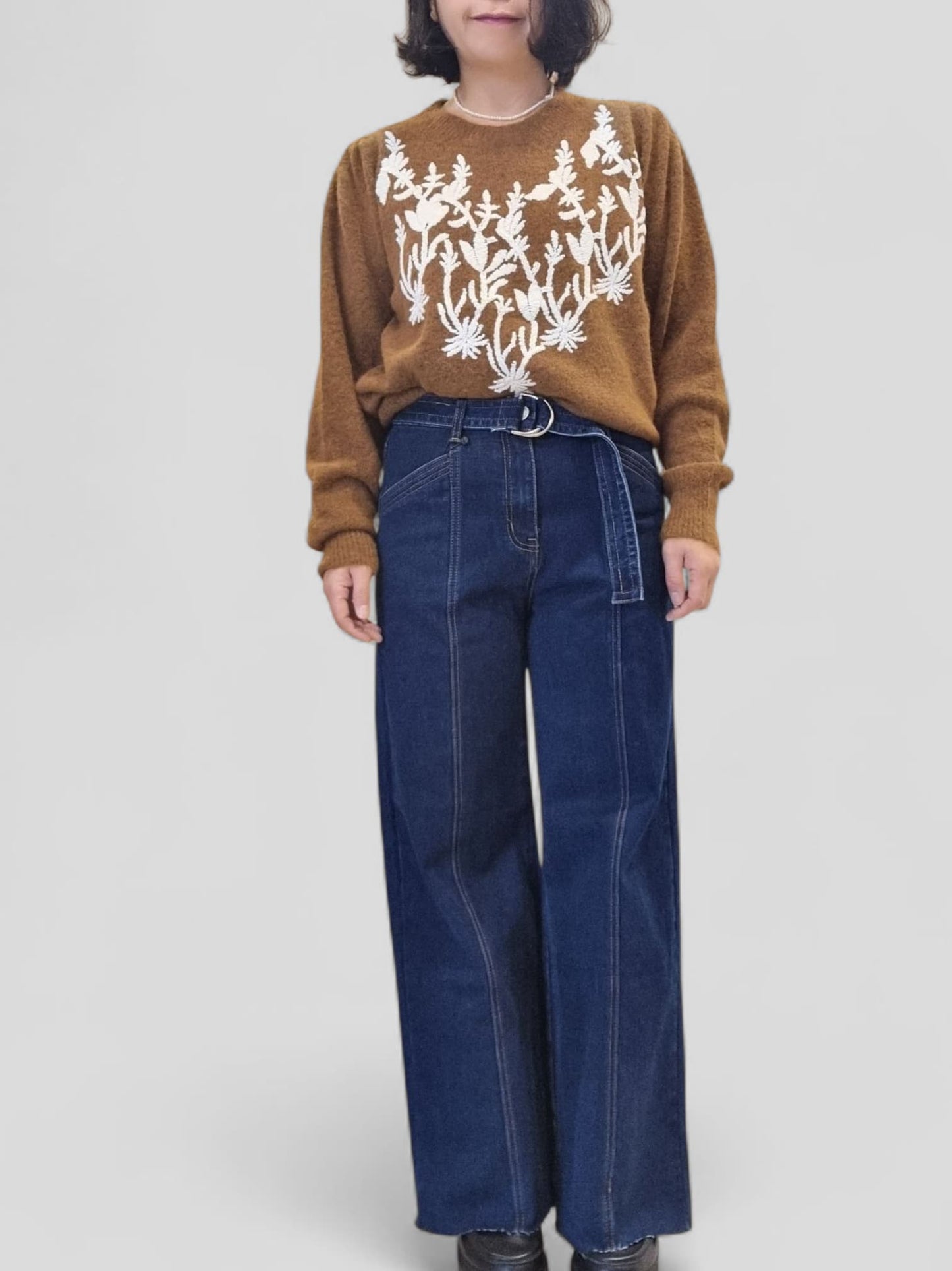 “Model wearing Dark Jean – high-waist denim styled with brown top, front view”