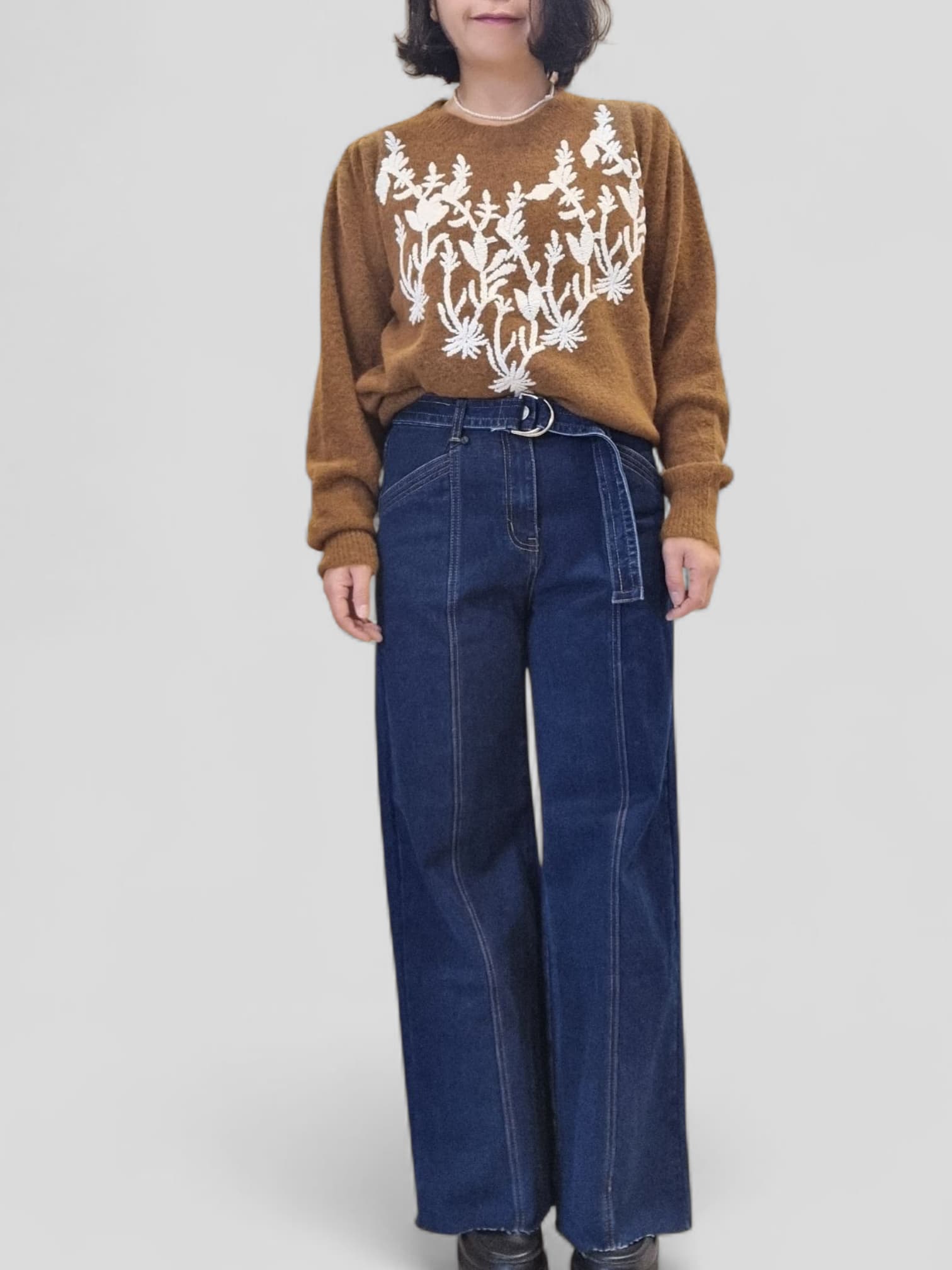 “Model wearing Dark Jean – high-waist denim styled with brown top, front view”