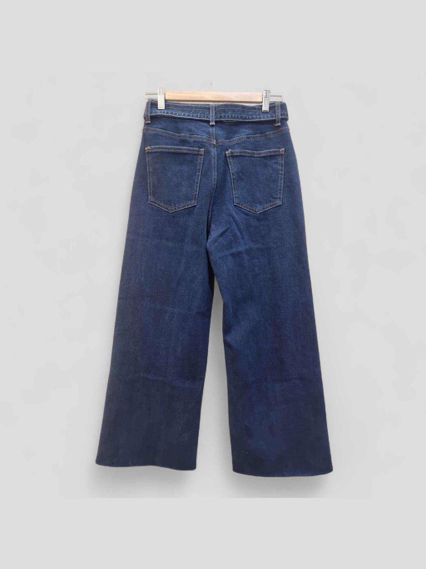 “Dark Jean flat lay – dark blue wide-leg jeans with belt on display”