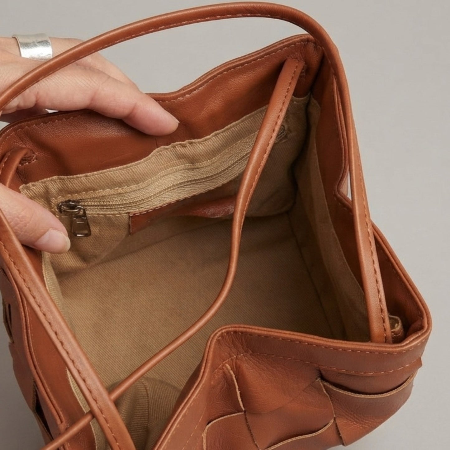 Interior view of brown woven genuine leather bag with spacious compartments