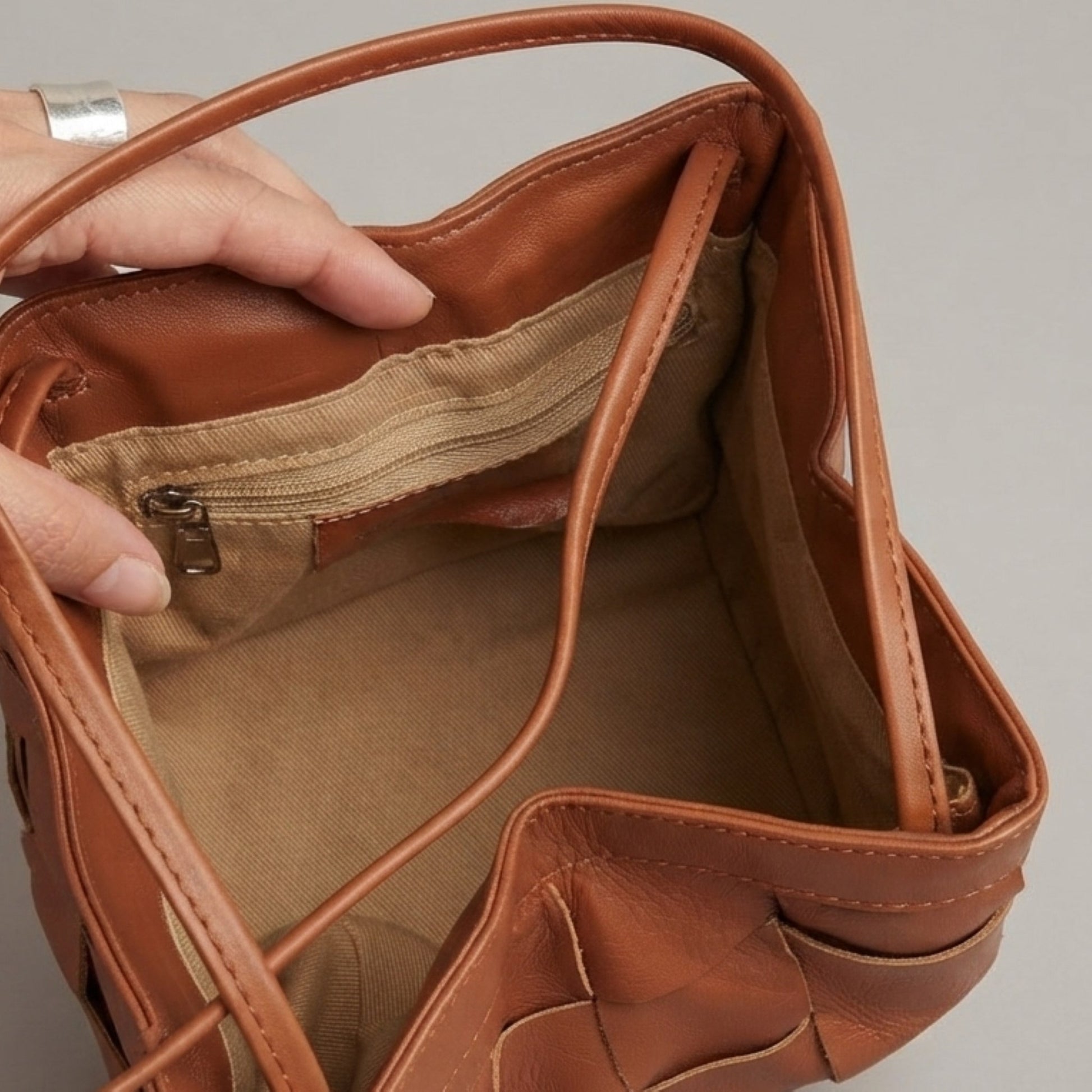 Interior view of brown woven genuine leather bag with spacious compartments