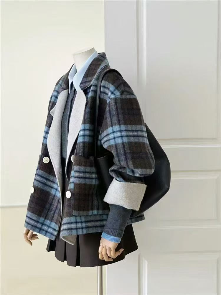 Blue plaid 100% wool jacket with a relaxed fit, double-breasted front, rolled cuffs, and soft winter styling.