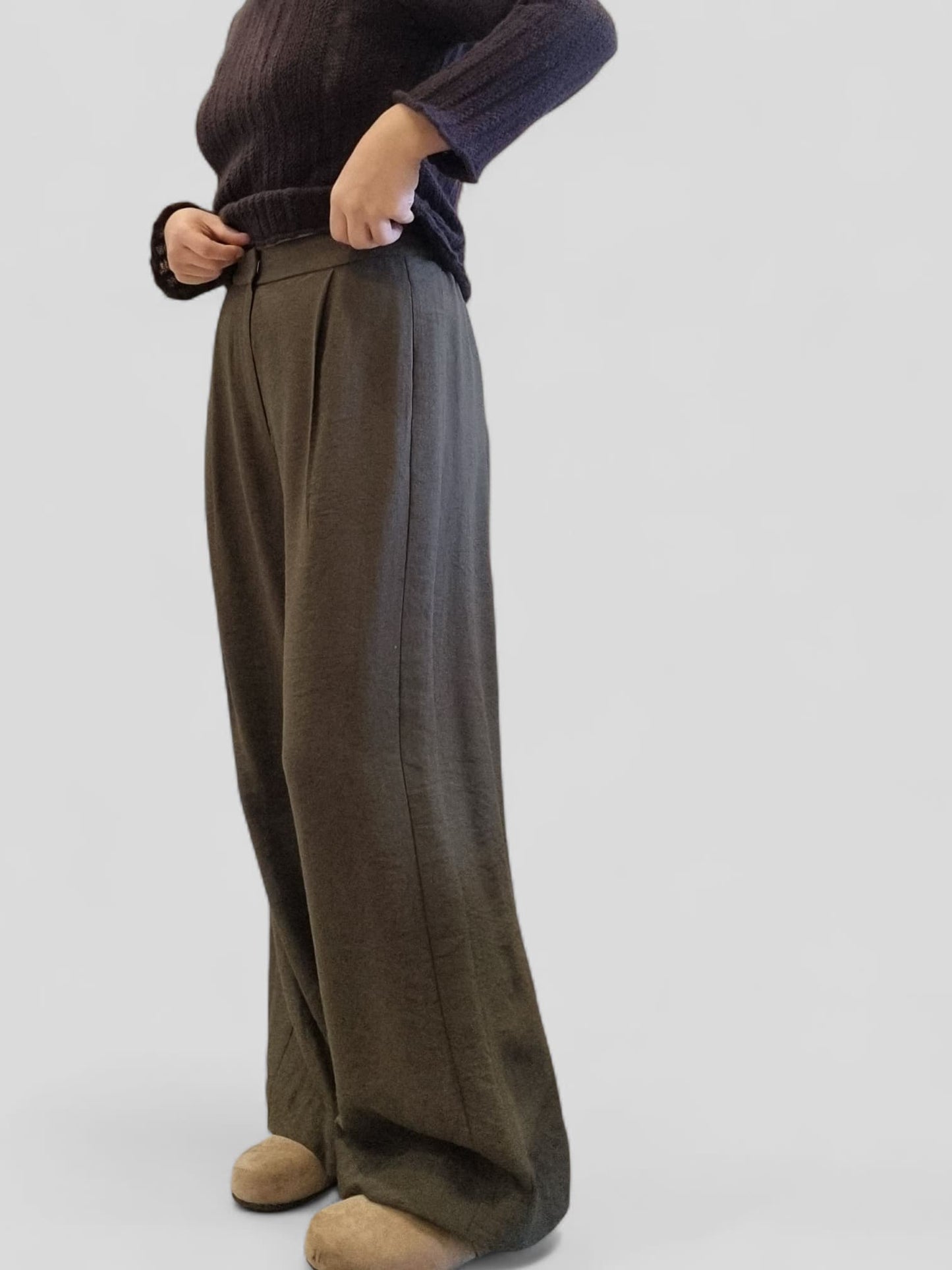 Side studio shot of khaki trousers in brown color variation