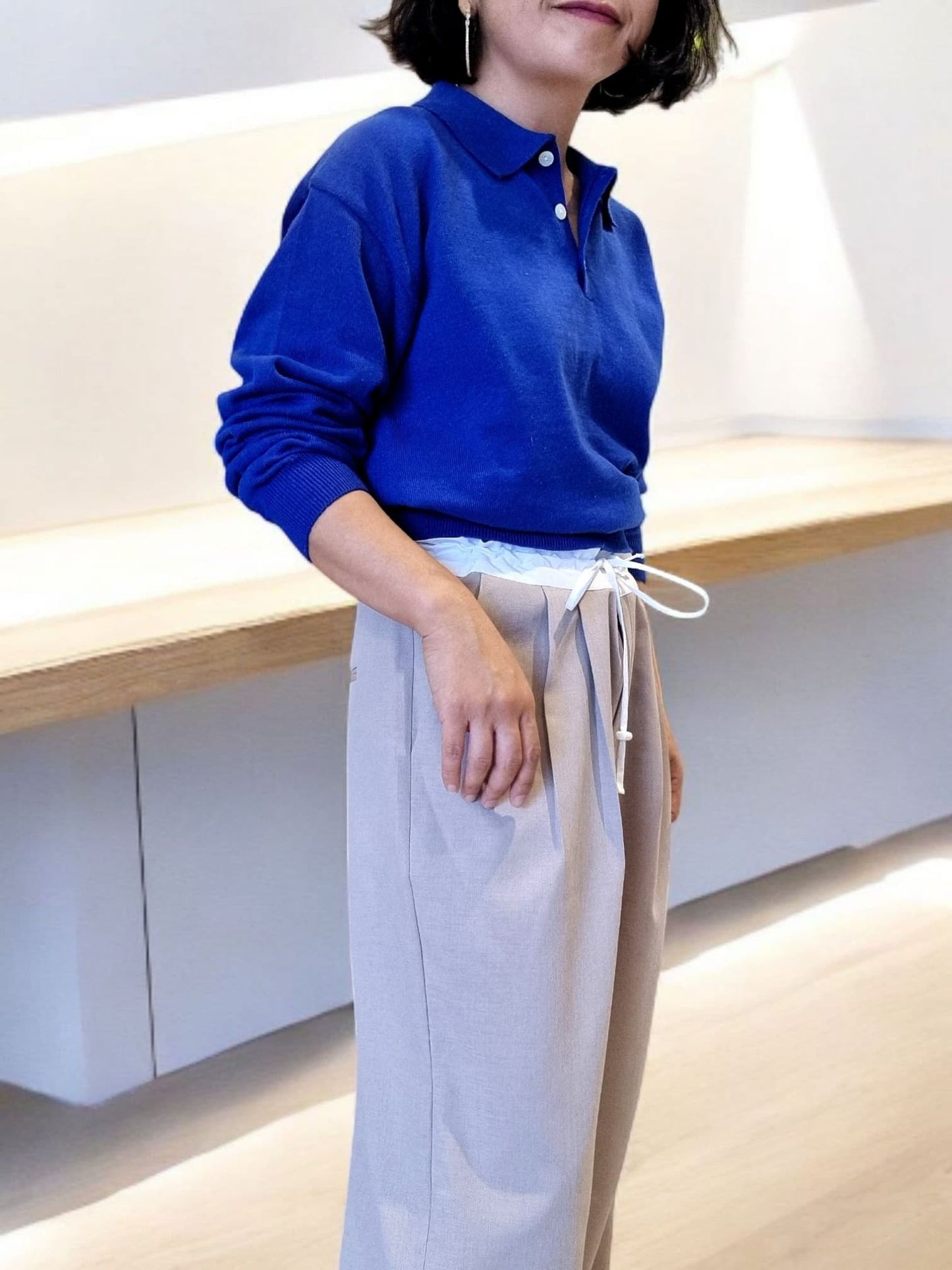 “Side view of royal blue cotton top paired with white trousers”