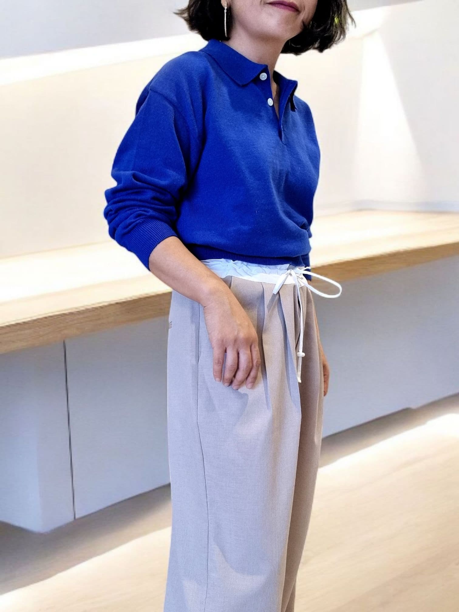 “Side view of royal blue cotton top paired with white trousers”